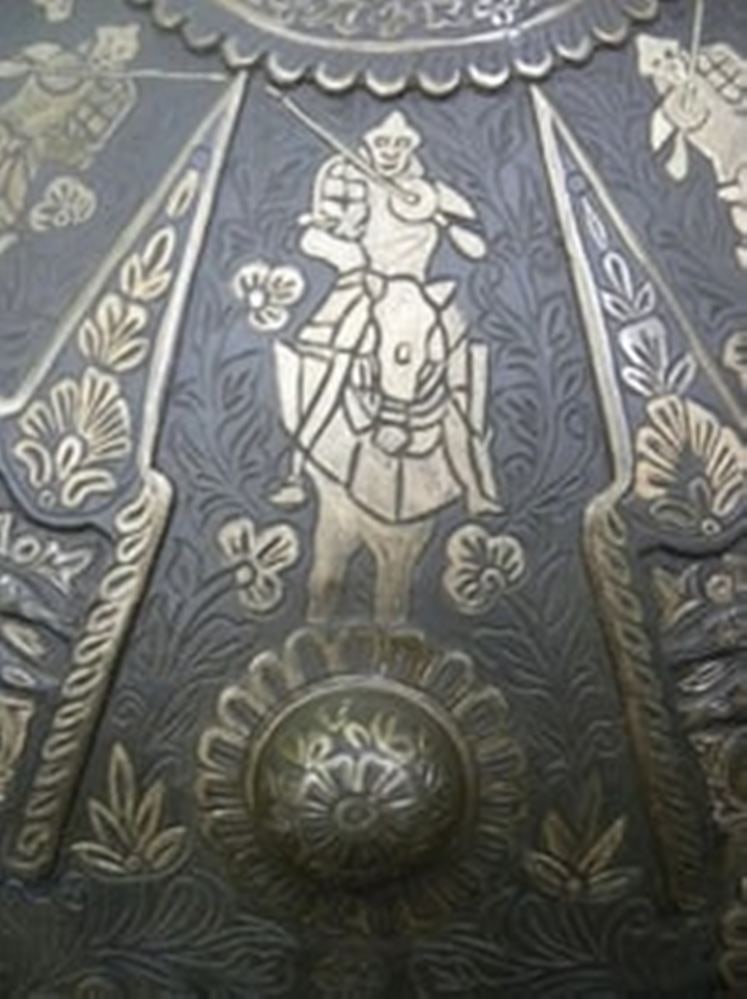 Ancient Antique Engraved Metal Shield Large Size Original 8 Dagger Inserted rare to find: This image showcases a beautifully crafted traditional metal shield with intricate hand-engraved designs. The circular shield features a prominent raised central boss, surrounded by symmetrical radial
