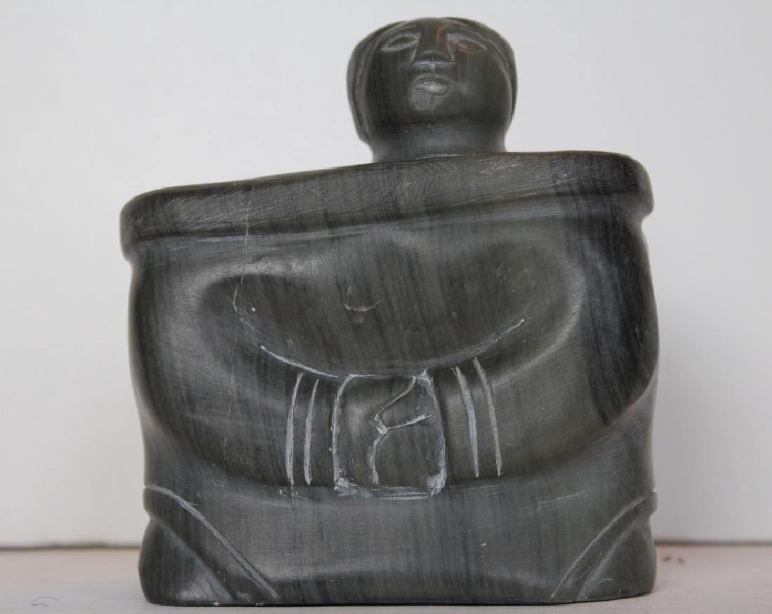 Inuit: Woman. Woman box like. Unframed. Medium: Stone. Size: 2" X 4" X4.5".
