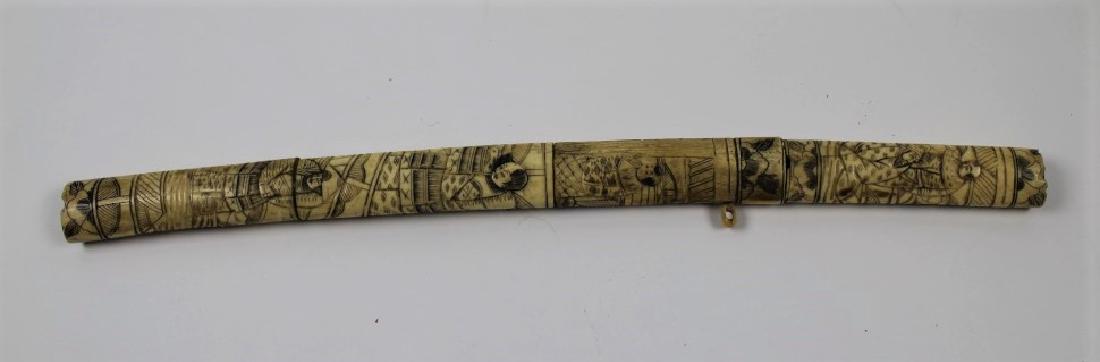 Bone samurai sword: Bone Samurai Sword. Beautiful sword with bone handle and holder, Sword and holder have Asian designs on them.. Size: 20".