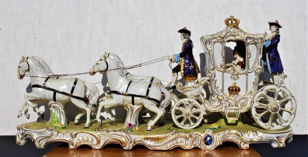 German coach figurine: German coach figurine. Title: Queen's Stagecoach. Medium: Porcelain. Size: 23.5 x 11.5 x 7 in. Artist: German. Unframed.