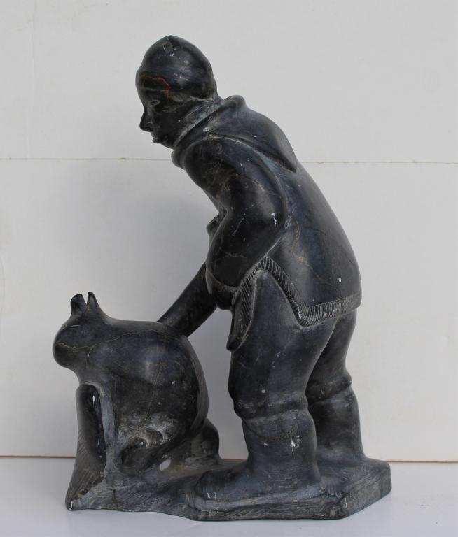 Moses Aupaluktuk inuit carving: Moses Aupaluktuk inuit carving. Man with a bird. Title: Inuit bird hunter. Medium: Sandstone. Size: 9 X 6 x 4 in. Signature: bottom. Artist: Moses Aupaluktuk. Unframed.