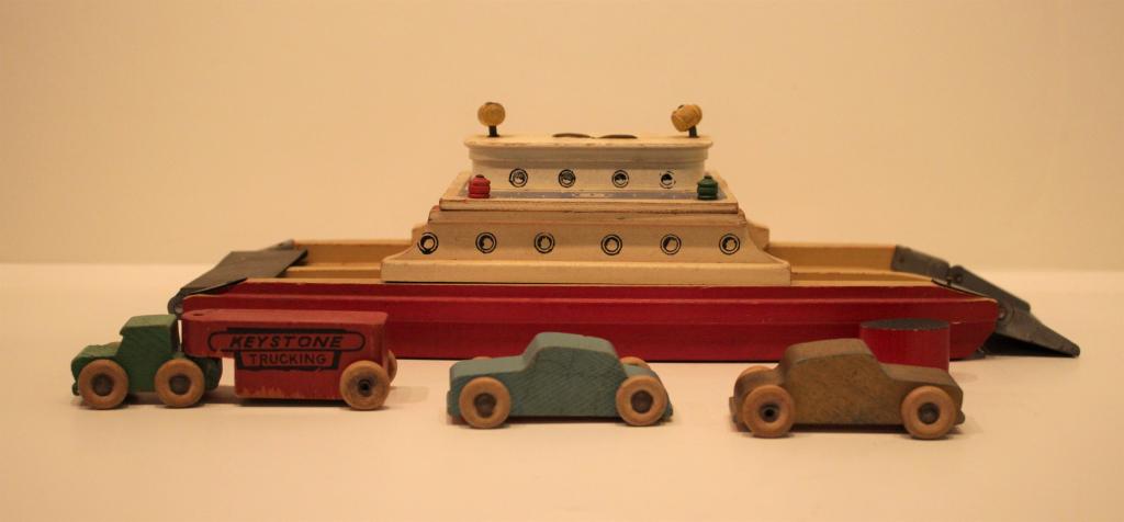 Wooden Ferry with cars: Wooden Ferry with cars. Title: Wooden Ferry with cars. Medium: Wood. Size: 3.5 X 12 XZ 5 in. Artist: Wooden Ferry with cars. Unframed.