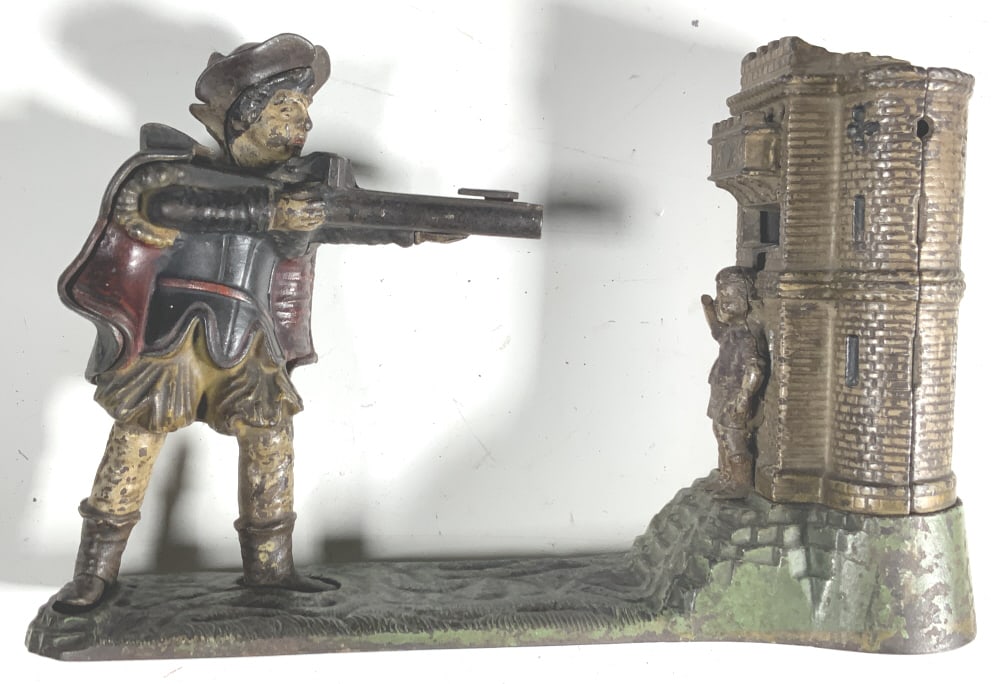 William Tell, cast iron, mechanical bank: William Tell, cast iron, mechanical bank. Title: William Tell. Medium: Cast iron. Size: 6.50 x10.50 x 3.75 in MORE PHOTOS ADDED, 8 AND 9, APPLE ON TOP OF HEAD AND ROUND DISK TO CLOSE BOTTOM