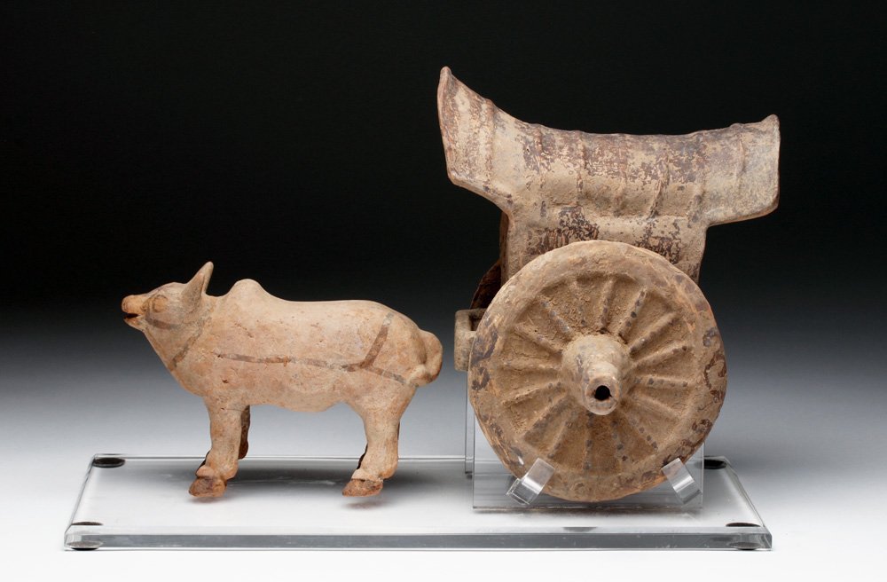 Han Dynasty Terracotta Bullock Cart Mingqi: Far East, China, Han Dynasty, ca. 206 BCE to 220 CE. Funerary object made from terracotta with handpainted details in black. The ancient Chinese buried precious items with the elite in order to ensure