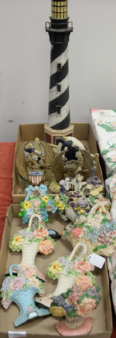 Two tray lots with iron door sops to include Cape: Two tray lots with iron door sops to include Cape Hatteras cast iron lighthouse door stop, cow door stop, seven basket of flower door stops, and two eagle doorstops.