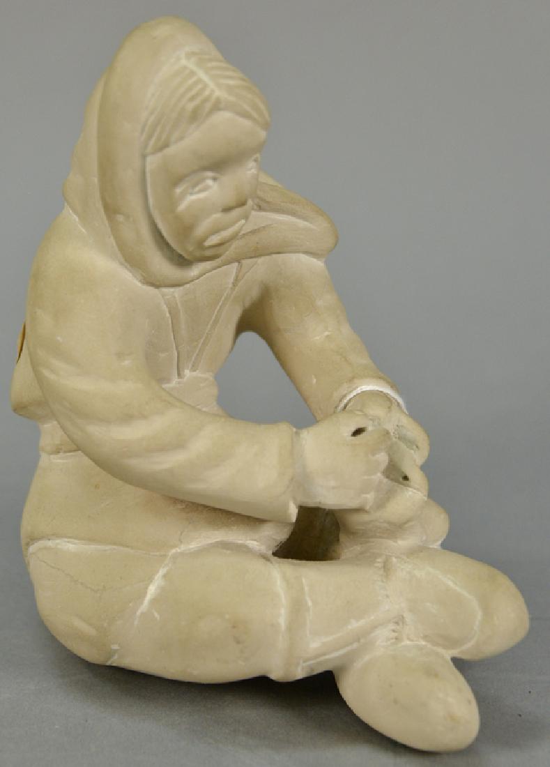 Inuit Eskimo carving Audlaluk Kupirkrualuk white: Inuit Eskimo carving Audlaluk Kupirkrualuk white serpentine Woman Stitching a Kamik, 7" x 5 3/4" x 4". Provenance: Waddington's 4/7/11 Auction