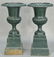 Pair of Victorian iron urns on square pedestal bases