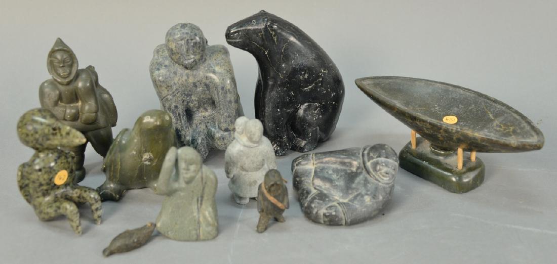 Group of ten Inuit Eskimo carvings to include: Group of ten Inuit Eskimo carvings to include serpentine Mother and Child, basalt Sitting Bear, Joan Attuat grey/green serpentine Inuk with Raised Hand, E. Paulosi (d. 1979) serpentine Whale Oil Lamp,