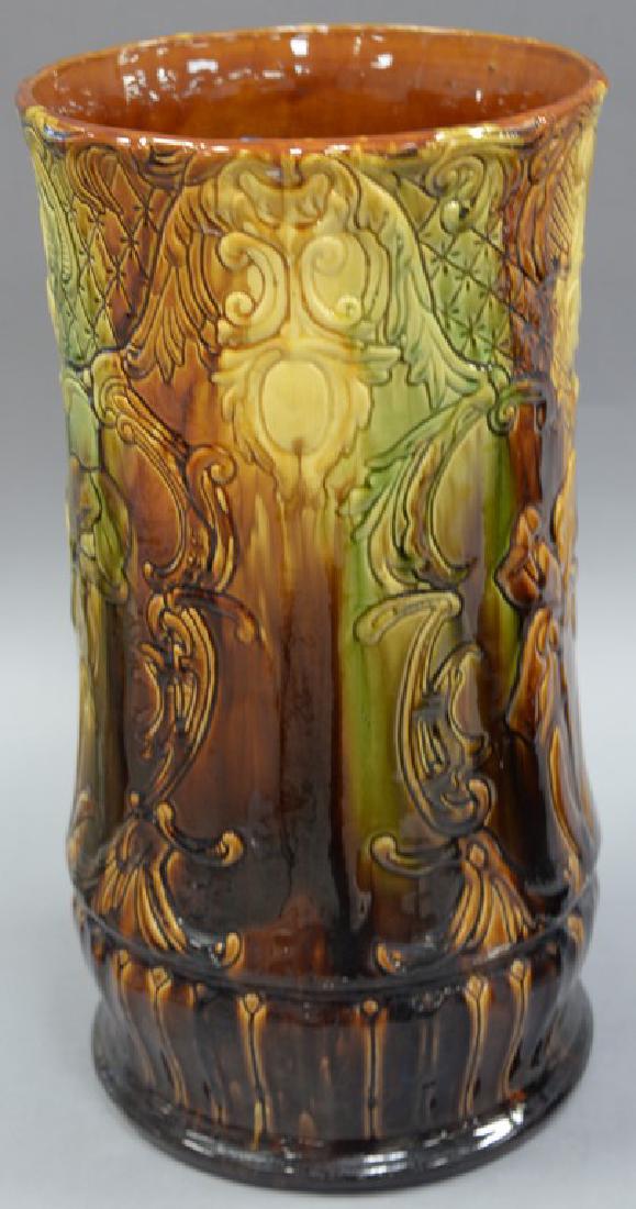 Majolica umbrella stand, green brown glazed with: Majolica umbrella stand, green brown glazed with embossed flower design.