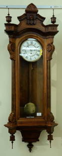 Seth Thomas walnut regulator clock with single brass: Seth Thomas walnut regulator clock with single brass weight.  ht. 52in., wd. 18 1/2in. Provenance: Property from the Estate of Frank Perrotti Jr. of Hamden, Connecticut