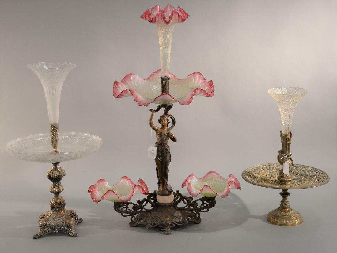 Three epergnes including Victorian epergne with brass: Three epergnes including Victorian epergne with brass base and pink and white art glass having three bowls and one vase (chip). ht. 29in., a large brass and pressed glass epergne having fish holder an