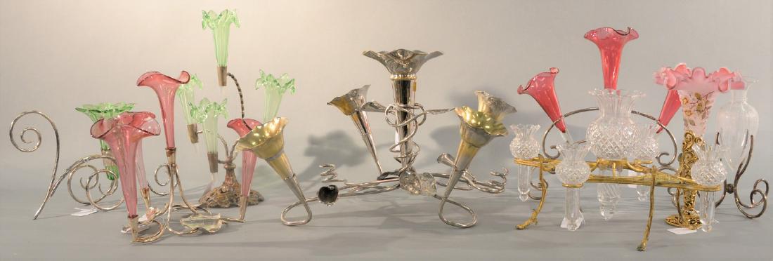Group of eight Epergnes, single vase with brass holder,: Group of eight Epergnes, single vase with brass holder, silverplated with green and cranberry vases, large epergne with with vase and leaf designs. Ht. 7in. to 13in. Provenance: Property from the Esta