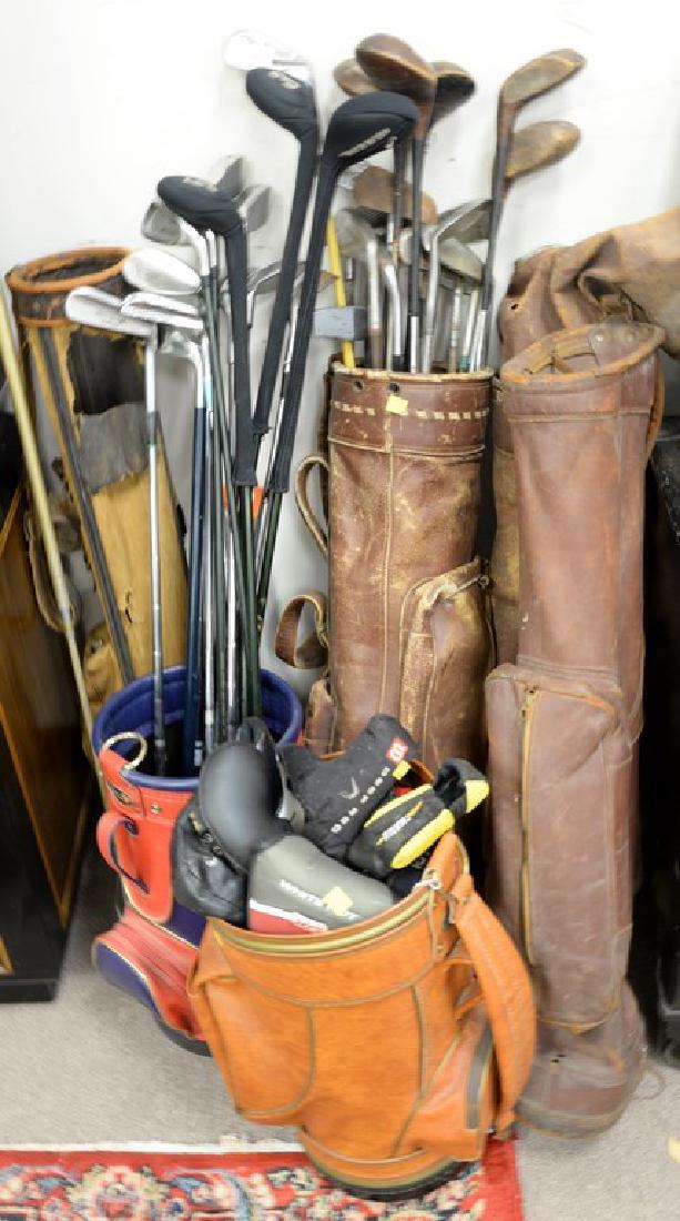 Group of golf equipment including sixteen recent clobs: Group of golf equipment including sixteen recent clobs (three with covers), fifteen vintage clubs with bag (as is), two bags (as is), two miniature bags, two golf ball pick-up tools, and nineteen club