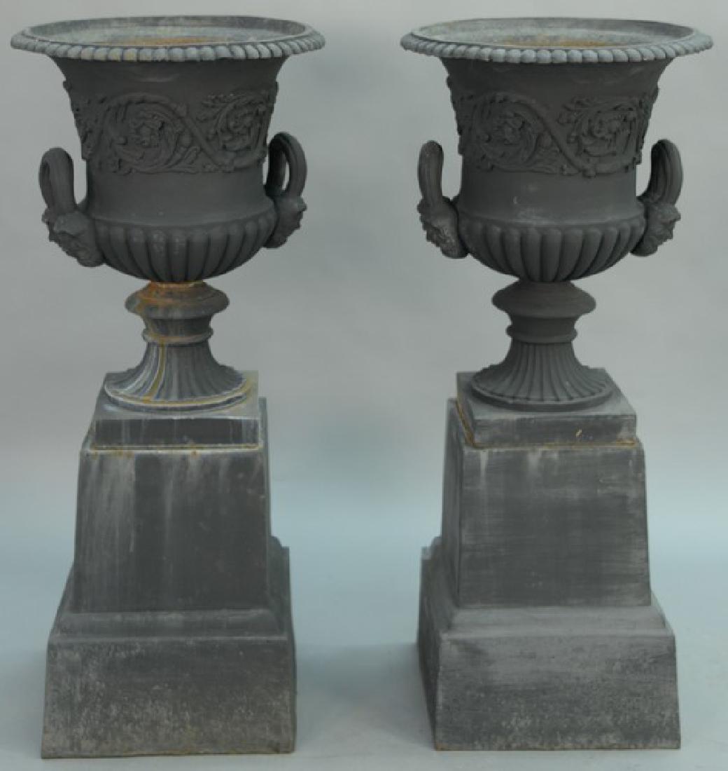 Pair of Victorian iron urns with handles and faces on (1 of 7)