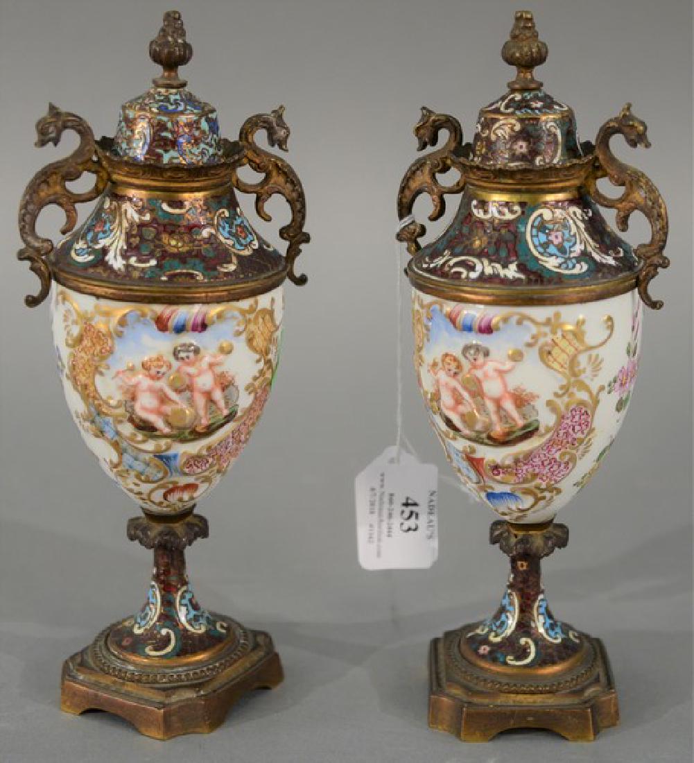 Pair of Capodimonte porcelain and champleve urns with: Pair of Capodimonte porcelain and champleve urns with metal mounts. height 9 inches
