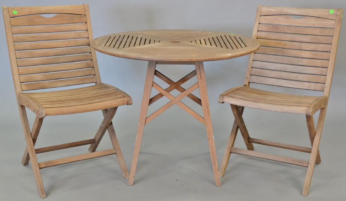 Three piece teak lot including round table and two (1 of 4)