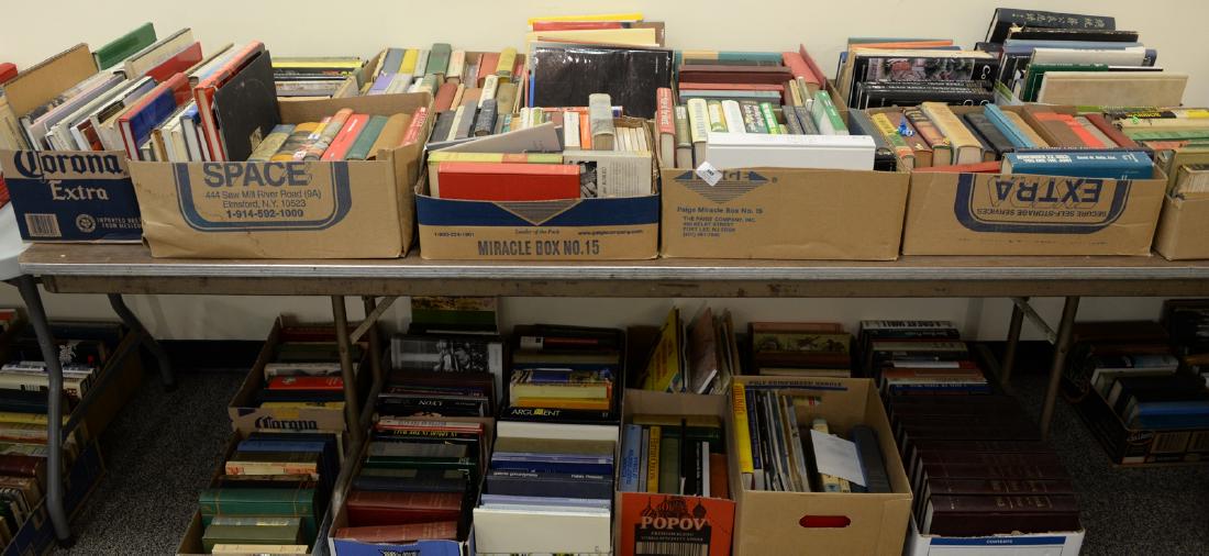 Table lot of books, on top and below table to include a (1 of 7)