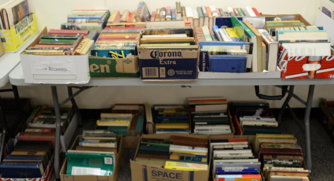 Table lot of books, on top and below table to include a (1 of 7)