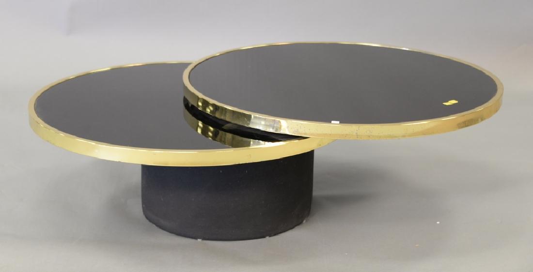 Institute of America brass and smoked glass swivel: Institute of America brass and smoked glass swivel cocktail table with black base (similar to Gabriella Crespi Elisse). ht. 14in. dia. 36in., opens to 54in.