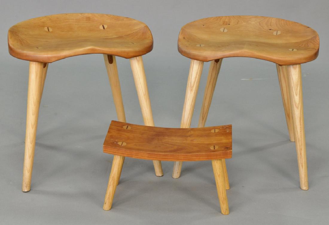 Three Thomas Moser cherry stools, two with molded seats: Three Thomas Moser cherry stools, two with molded seats and a small stool marked on bottom.