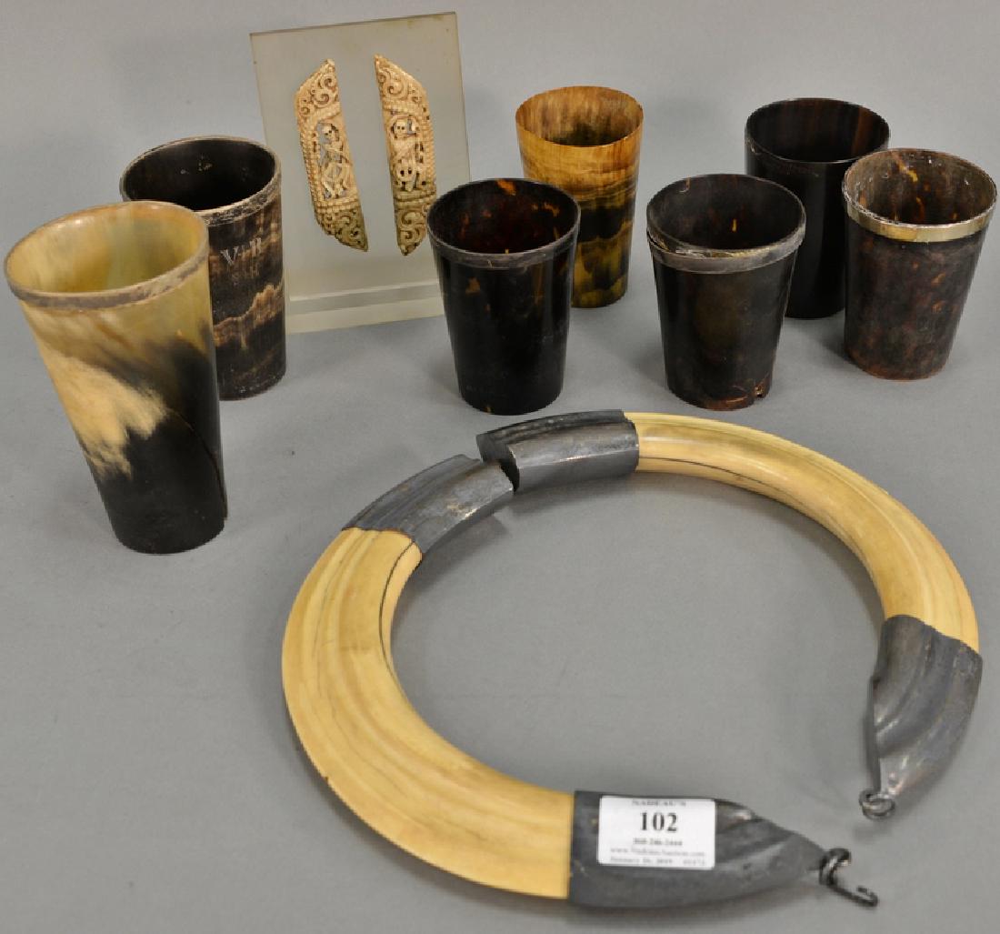 Horn tusk group including group of seven horn cups: Horn tusk group including group of seven horn cups (most with silver rim), boar tusk necklace, and carved bone in the form of skeleton. cup ht. 4 in. to 6 in. Provenance: Estate of Kenneth Jay Lane*IM