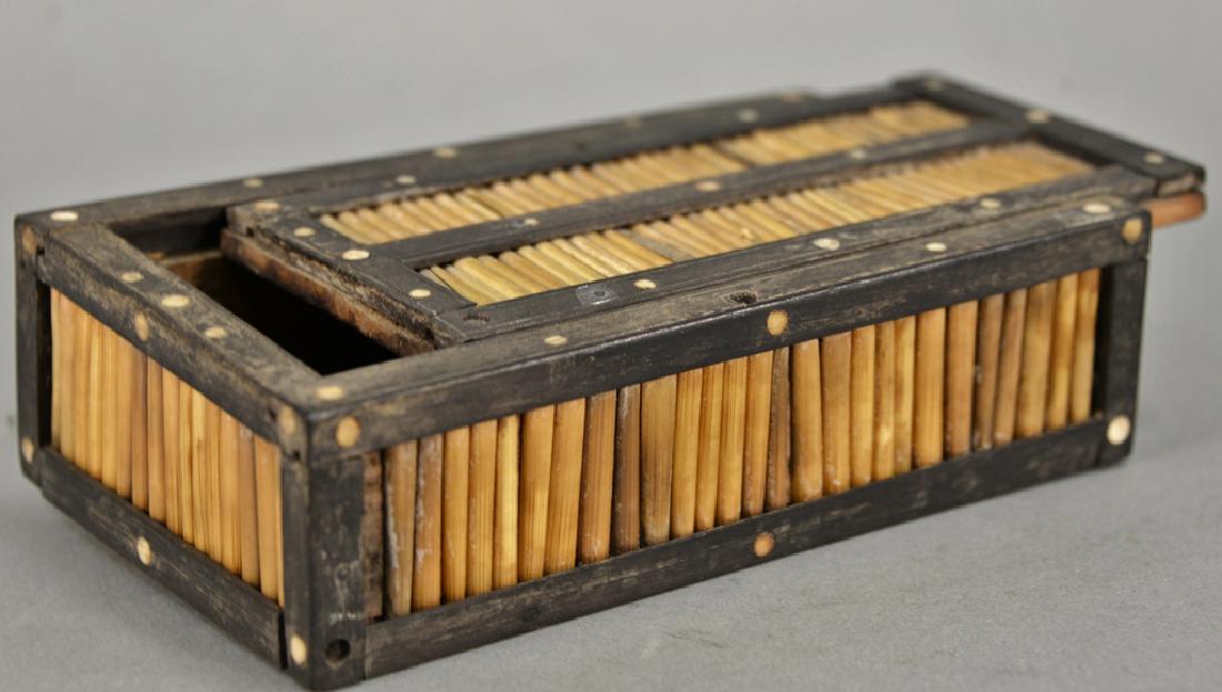 Wood and porcupine quill casket, decorated with wood: Wood and porcupine quill casket, decorated with wood borders and bone roundels at intervals with slide top. ht. 2 in., lg. 7 in. Provenance: Estate of Kenneth Jay Lane, Sotheby Parke Bernet #251 The K