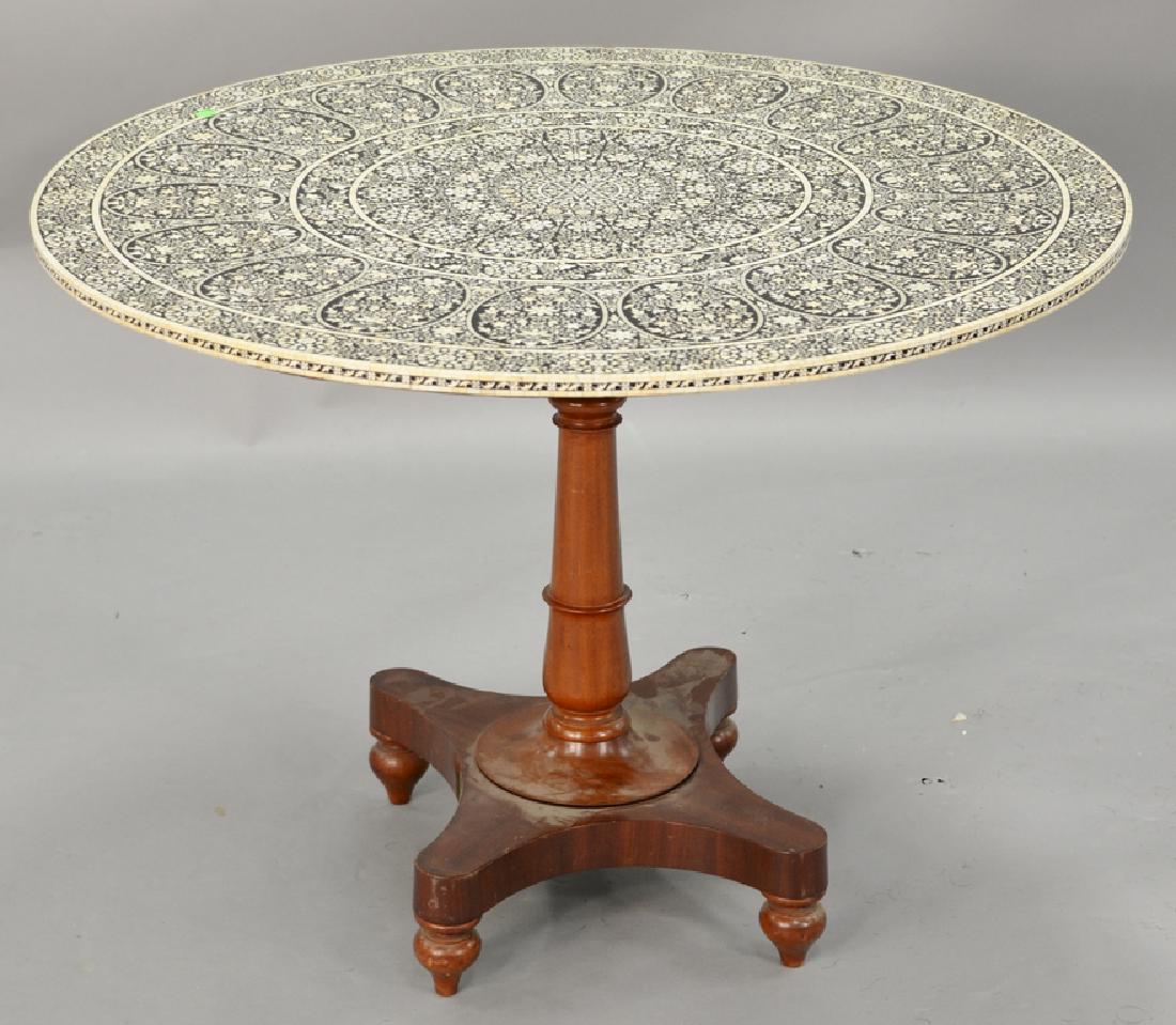 Eastern tip top table having bone and ebony inlaid: Eastern tip top table having bone and ebony inlaid round top on pedestal base (loose). ht. 29 in., dia. 40 in. Provenance: Estate of Kenneth Jay Lane*IMPORTANT NOTE: No credit card payments will be ac