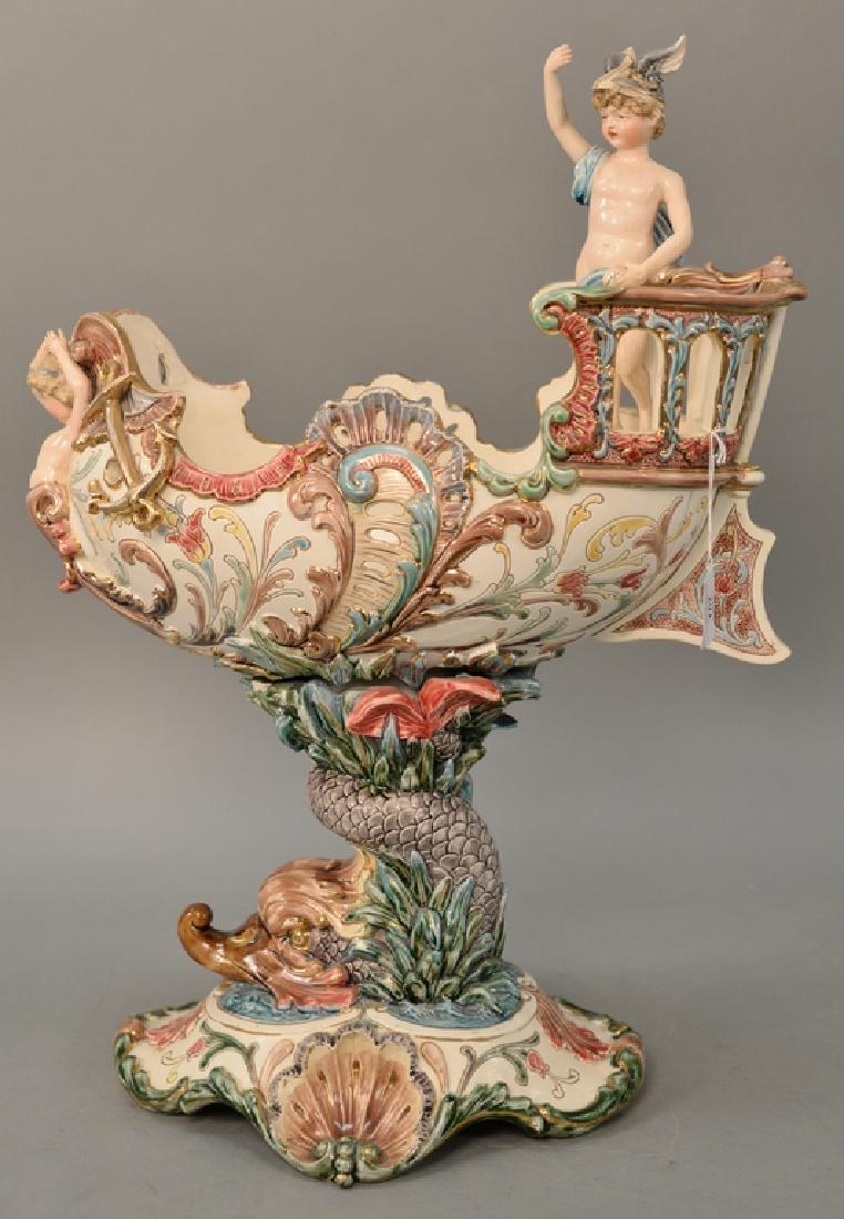 Eichwald Majolica figural centerpiece compote having: Eichwald Majolica figural centerpiece compote having dolphin support, marked: Eichwald 1087 (repaired). ht. 23 in., lg. 17 in.