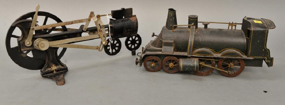 Group lot to include painted tin toy train, an iron: Group lot to include painted tin toy train, an iron mechanical locomotive, and Peter Rabbit Chick Mobile by Lionel (as is). lg. 14 1/2'' - 15''