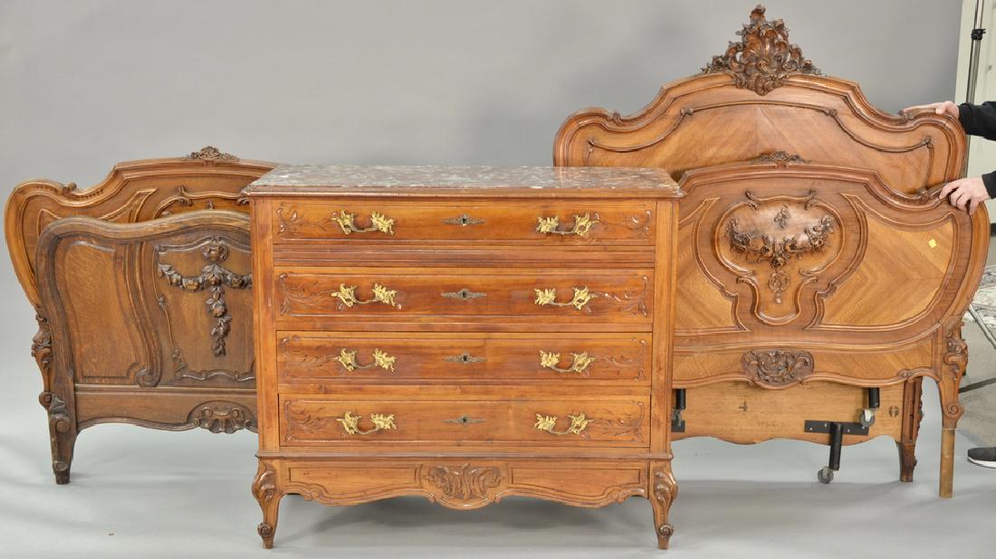 Three piece lot to include Louis XV style chest with: Three piece lot to include Louis XV style chest with inset marble top. ht. 41 in., wd. 47 in. and two carved rococo style twin beds (no rails). ht. 59 in. & 43 in. Provenance: From an estate in Lloyd 