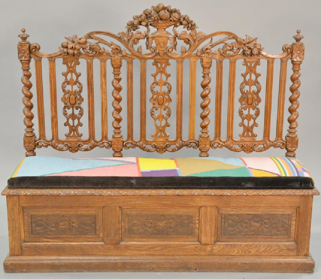 Oak bench with lift seat and carved back. ht. 50 in.,: Oak bench with lift seat and carved back. ht. 50 in., wd. 59 in.