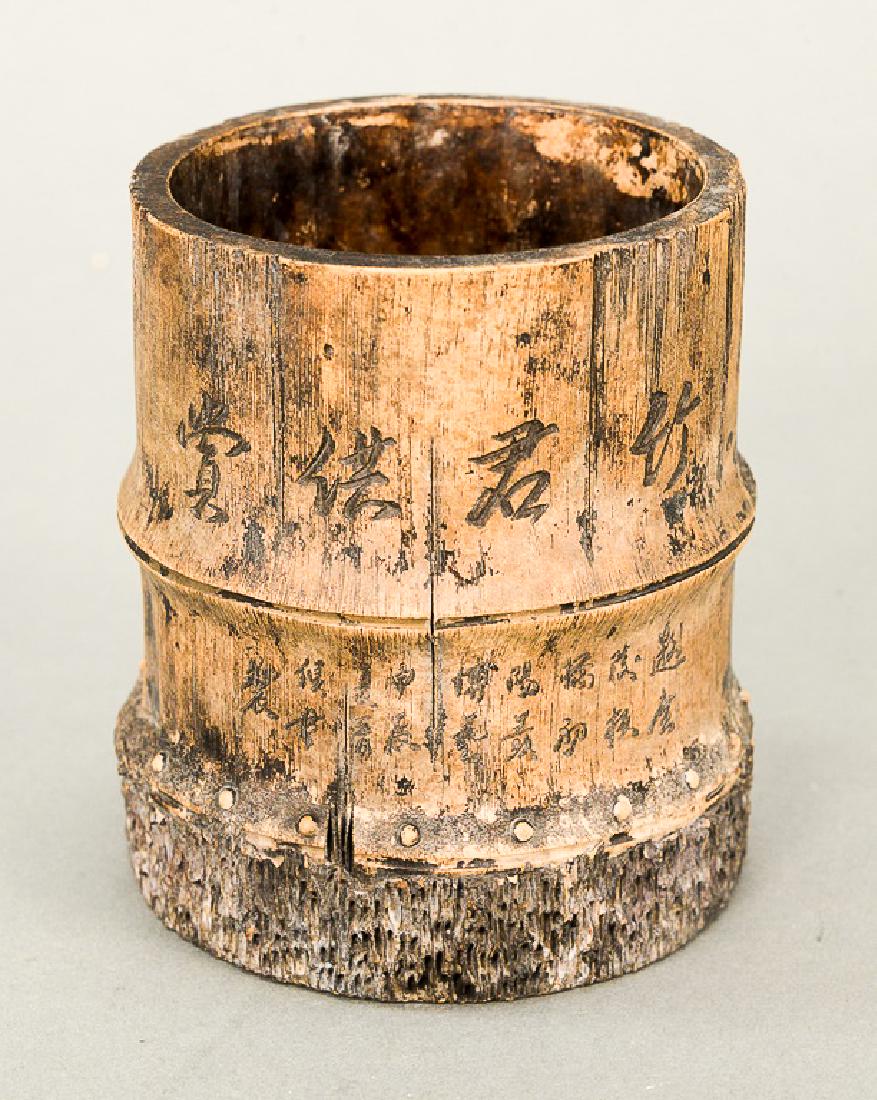 Grey pottery (Yixing) faux bamboo brush pot, China: Grey pottery (Yixing) faux bamboo brush pot, China 19th/20th century, the clay body with a lower band of root nodules and upper bands of incised calligraphy and bamboo. ht. 4 3/4 in.