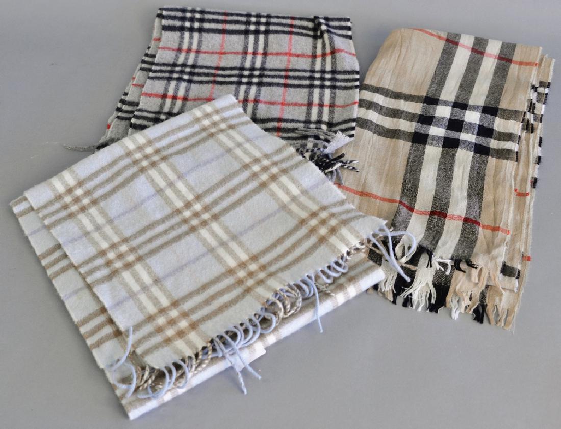 Three Burberry scarves or shawls, two are marked: Three Burberry scarves or shawls, two are marked cashmere.
