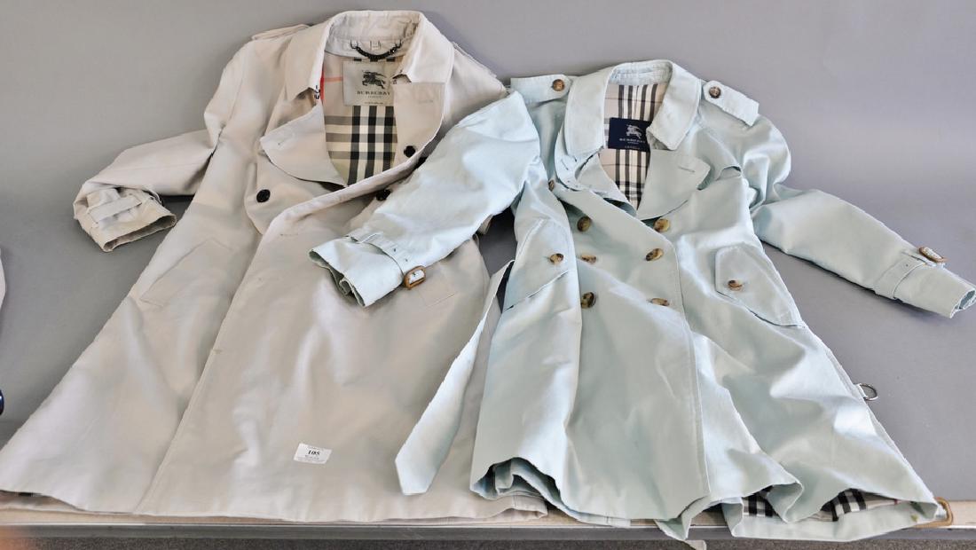 Two Burberry trench coats including a Burberry mens: Two Burberry trench coats including a Burberry mens trench coat, size 14 and a woman's Burberry trench coat along with a liner.