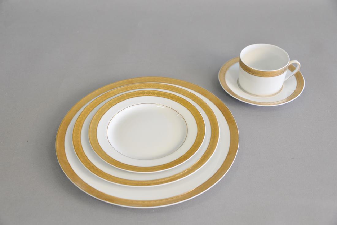 Bernardaud Limoges "Rhapsody" porcelain dinnerware with: Bernardaud Limoges "Rhapsody" porcelain dinnerware with gold rim, 54 total pieces to include 10 dinner, 10 saucers, 10 dessert, 10 salad, 10 cups, and 4 miscellaneous.