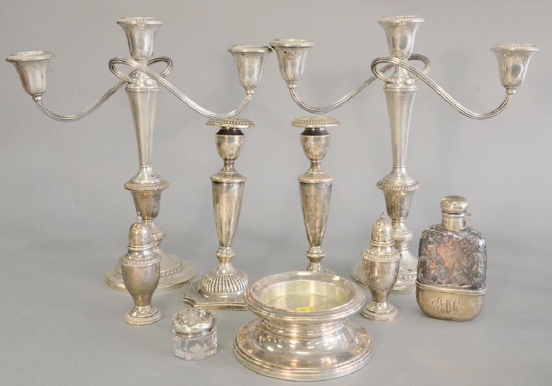 Group of sterling silver to a pair of sterling silver: Group of sterling silver to a pair of sterling silver weighted candelabras (ht. 12 1/4 in.), candlesticks, salt and pepper, small box, and a silver overlay flask.