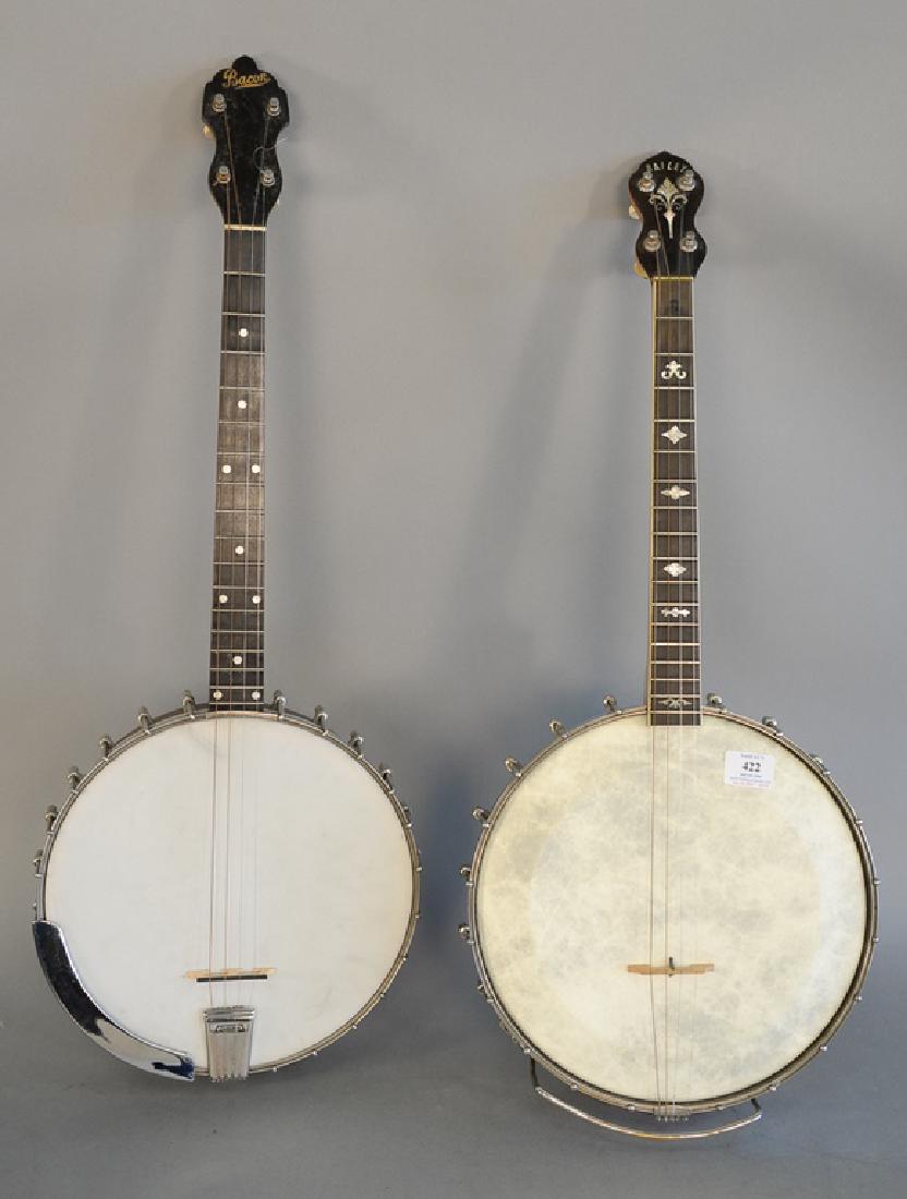 Two banjos, Bacon four string, Groton CT drum top solid: Two banjos, Bacon four string, Groton CT drum top solid bridge, no warp on neck, hardshell case; and a EL Baile, Brooklyn NY four string, no resonator drum top in cased body with hardshell case.