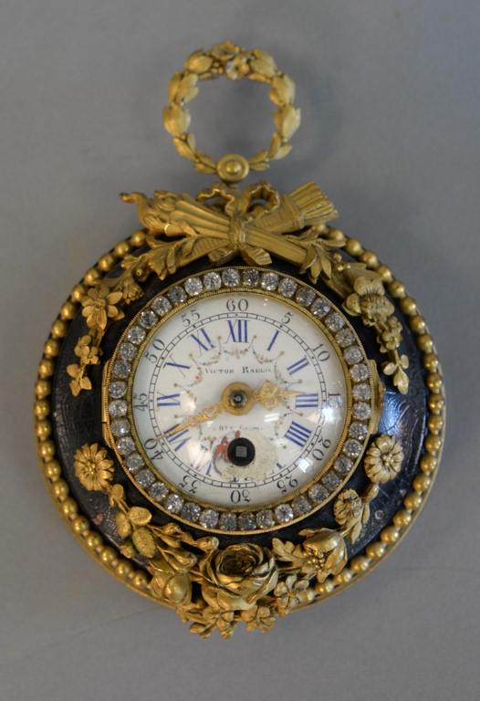 Small Victor Raulin French hanging clock having glass: Small Victor Raulin French hanging clock having glass rosettes around enameled face, bronze mounted frame. ht. 6 1/2 in.