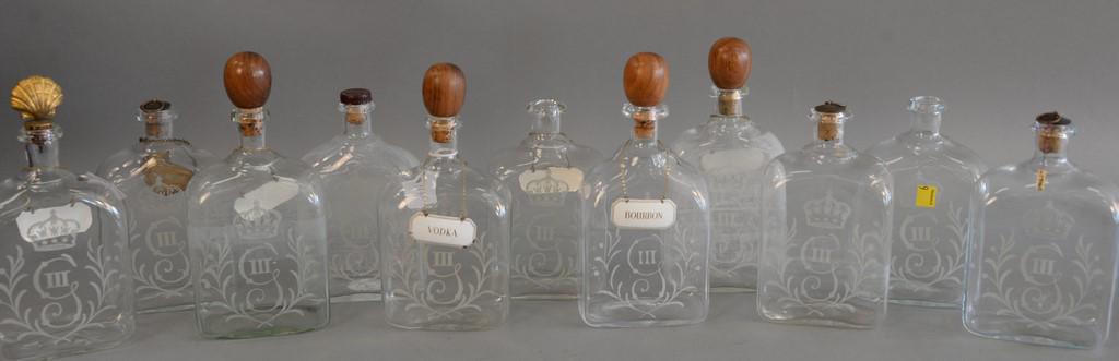 Group of eleven English etched glass decanters, each: Group of eleven English etched glass decanters, each with rectangular section, one side wheel engraved with a George III style cypher. ht. 7 1/2 in. to 10 in.