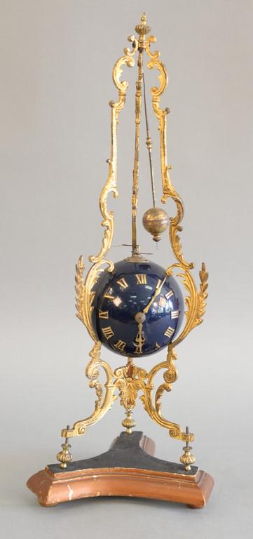 Continental ormolu and blue globular table clock on: Continental ormolu and blue globular table clock on foliate cast open supports with spherical movement housing. ht. 17 in.