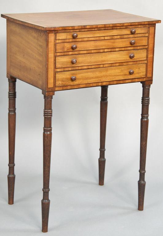 Sheraton mahogany and satinwood work table, having four: Sheraton mahogany and satinwood work table, having four graduated drawers set on tapered and turned legs. height 28 3/4 inches, top: 19" x 13 1/2".