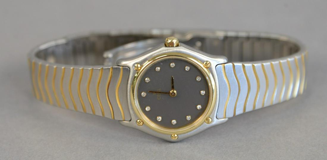 Ebel womans wave gold steel and diamond wristwatch: Ebel womans wave gold steel and diamond wristwatch having gold bezel with black dials and diamond markers.