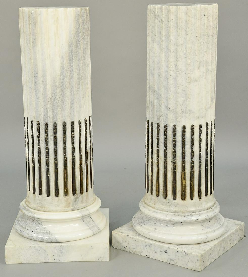 Pair of White Marble Pedestals, column style with brass: Pair of White Marble Pedestals, column style with brass stop fluting, set on round and square bases (small, minor chips at top). height 39 inches, diameter 10 3/4 inches.