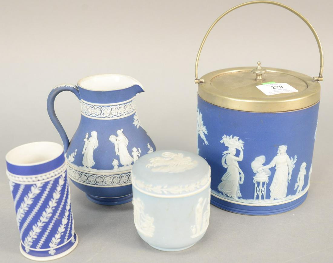 Group of four blue and white Wedgwood Jasperware to: Group of four blue and white Wedgwood Jasperware to include biscuit jar, creamer and covered sugar and a cup. creamer ht. 5 1/2 in. Provenance: Former home of Mel Gibson, Old Mill Rd, Greenwich, CT