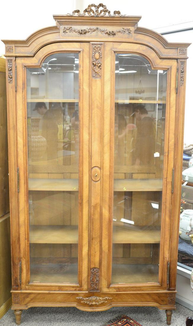 Louis XVI style two door display cabinet with beveled: Louis XVI style two door display cabinet with beveled glass doors. ht. 97 in., wd. 53 in. Provenance: The Estate of Ed Brenner, Short Hills N.J.