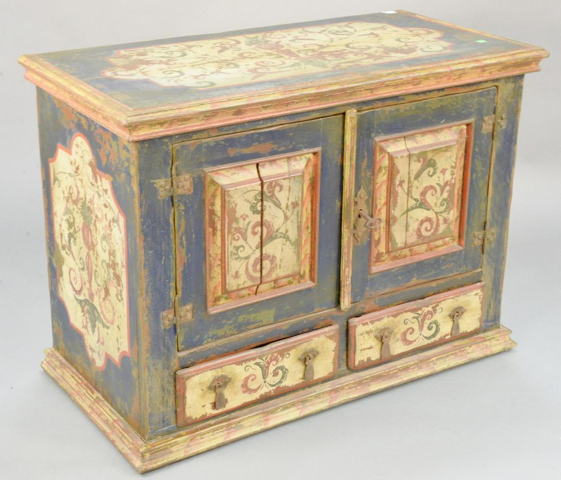 Paint decorated cabinet having two doors and two: Paint decorated cabinet having two doors and two drawers. ht. 31, wd. 42 in. Provenance: Former home of Mel Gibson, Old Mill Rd, Greenwich, CT