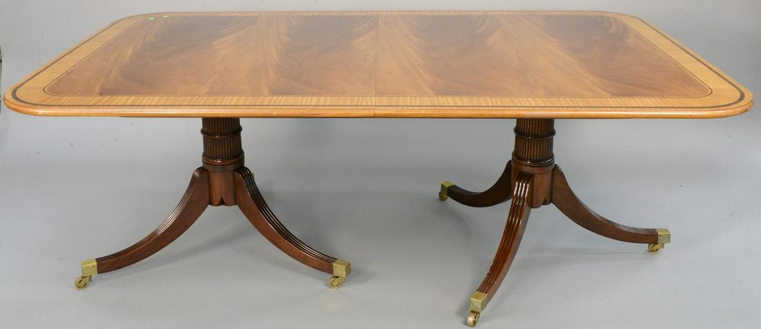 Baker Furniture mahogany double pedestal dining table: Baker Furniture mahogany double pedestal dining table having wide banded inlaid top on double pedestal base with three 19" extra leaves and custom pads. ht. 28 inches, top: 48" x 78" total top lg: 135