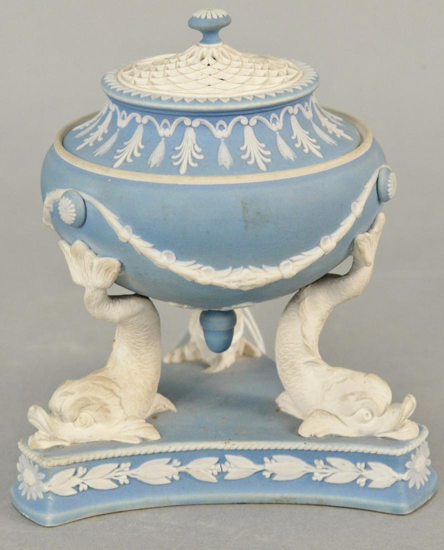 Wedgwood pale blue Jasper tripod urn with pierced: Wedgwood pale blue Jasper tripod urn with pierced cover, supported on dolphin legs, classical motifs throughout, Wedgwood stamp on bottom, wear consistent with age including light surface wear. ht. 5 