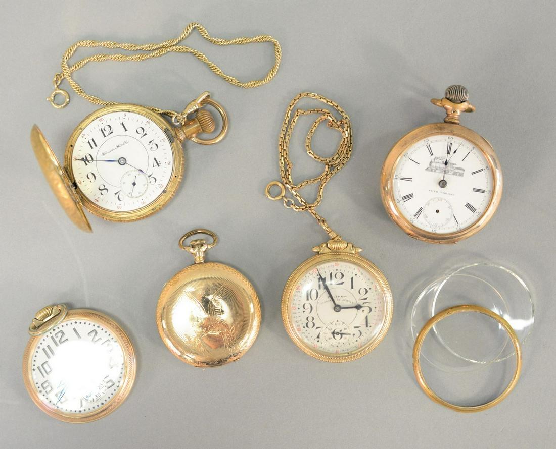 Five gold plated pocket watches, includes: a Seth: Five gold plated pocket watches, includes: a Seth Thomas with train on dial; with eagle on case; Hampden with train on back, etc.