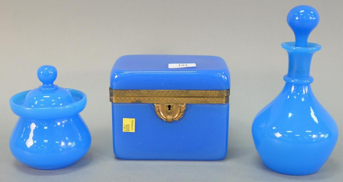 Three pieces of blue opaline glass, including: decanter: Three pieces of blue opaline glass, including: decanter with stopper, 9" h.; covered jar, 5 1/2" h.; and large blue opaline box with lid, gilt brass escutcheon plate and collar with filigree design, m